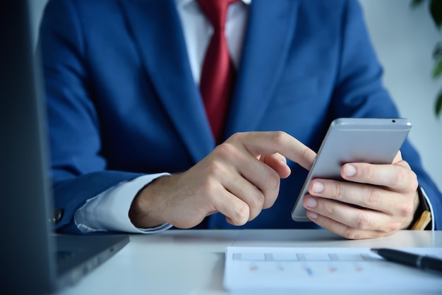 Businessman using smartphone in modern office