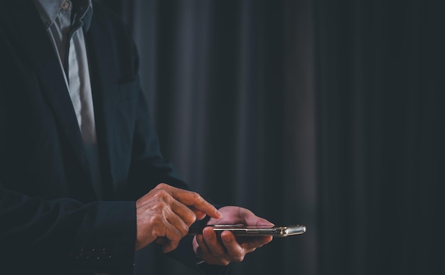 Businessman using smartphone at night time