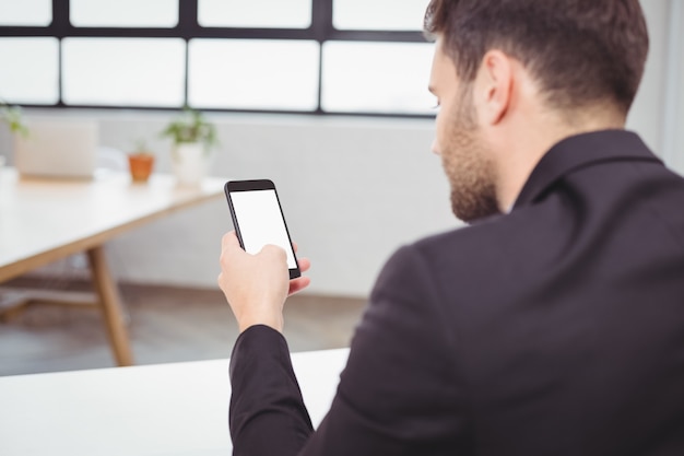 Businessman using smartphone in office