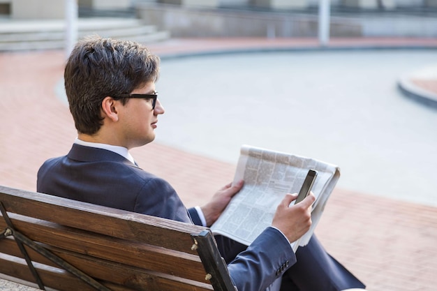 Businessman using smartphone outside