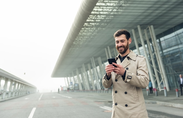 Businessman using smartphone while walking