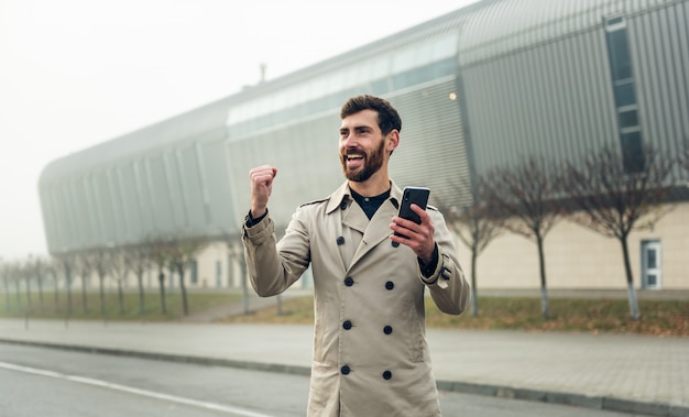 Businessman using smartphone while walking