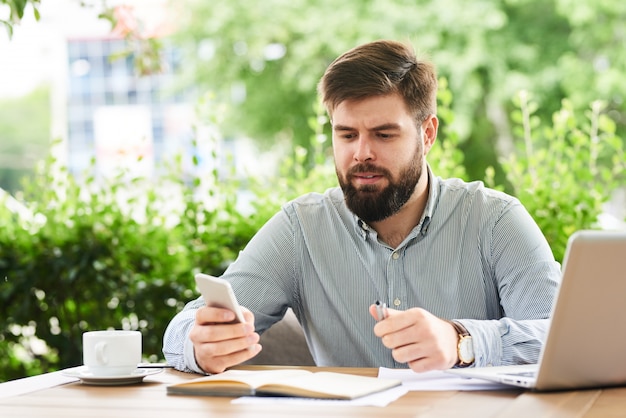 Businessman Using Smartphone for Work