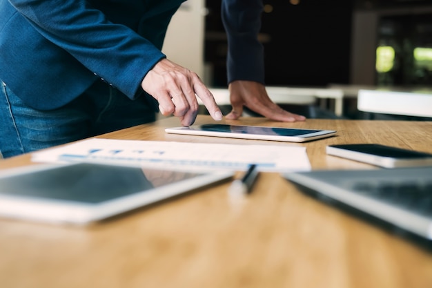 Businessman using tablet analyse data.