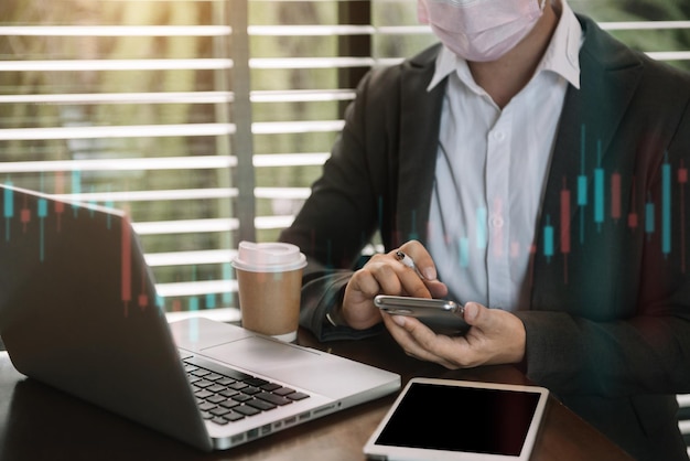 Businessman using a tablet to analysis graph company financial in office