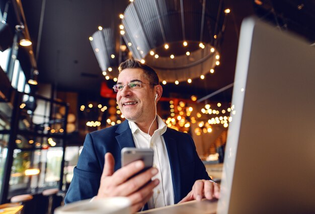 Businessman using technologies at coffee shop.