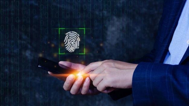 Businessman using touching smart phone with scanning\
fingerprint biometric identity and authorization futuristic concept\
of password security and control through fingerprint in future