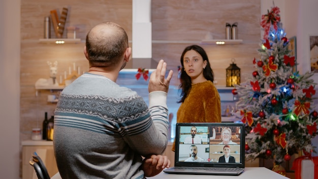 Businessman using video call for work on christmas eve