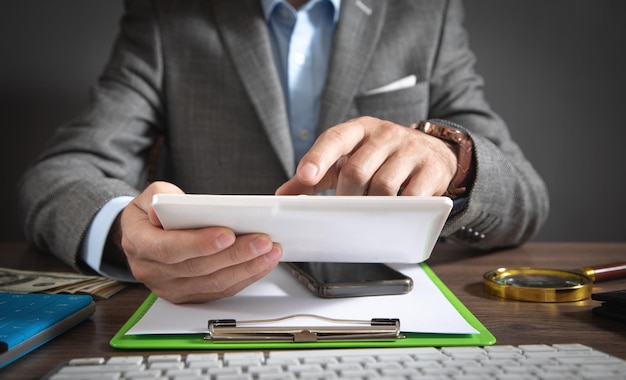 Businessman using white digital tablet