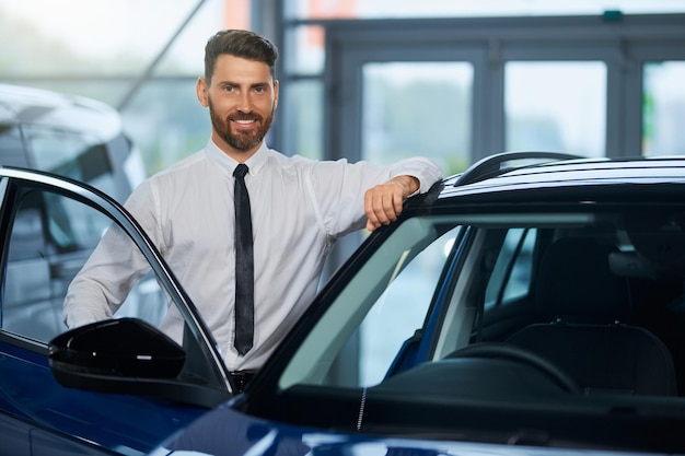 Businessman visiting auto salon for choosing new vehicle