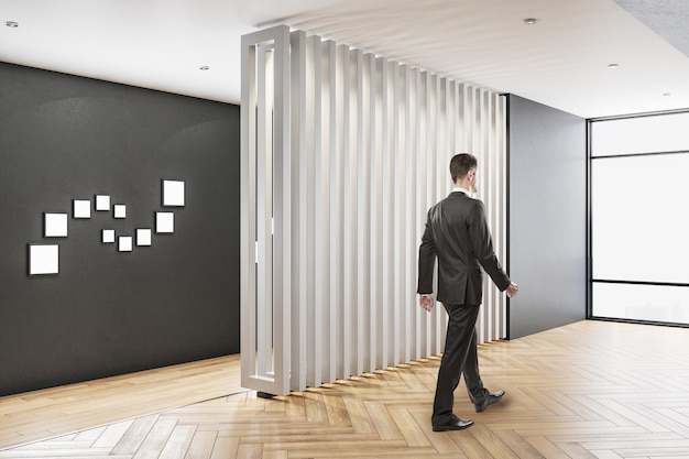 Businessman walking in contemporary office interior