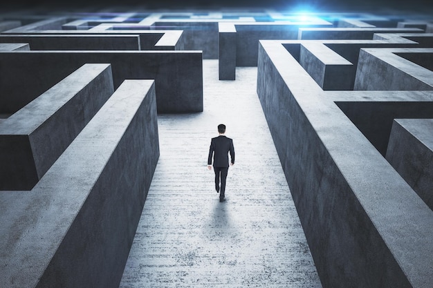 Businessman walking at entrance to a maze