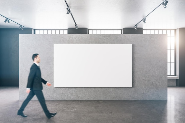 Businessman walking in gallery hall interior