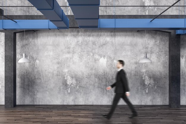 Photo businessman walking in loft interior room with blank wall and wooden floor art and design concept