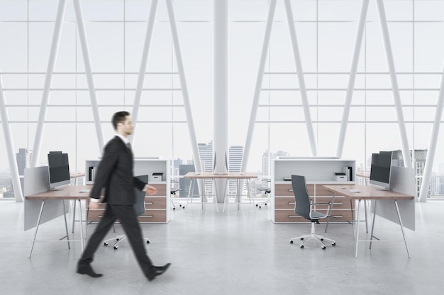 Businessman walking in modern concrete coworking office interior with panoramic window and city view equipment daylight and wooden furniture