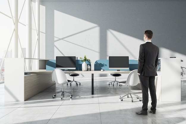 Businessman walking in modern hipster coworking office interior with sunlight furniture equipment and bike Workplace concept