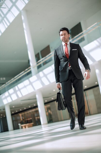 Businessman walking near the office building