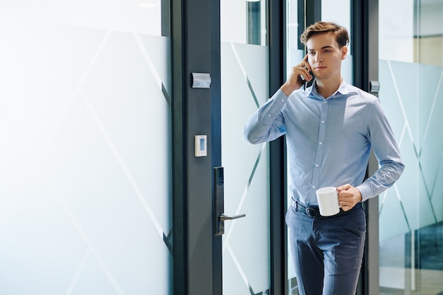 Businessman walking in office corridor