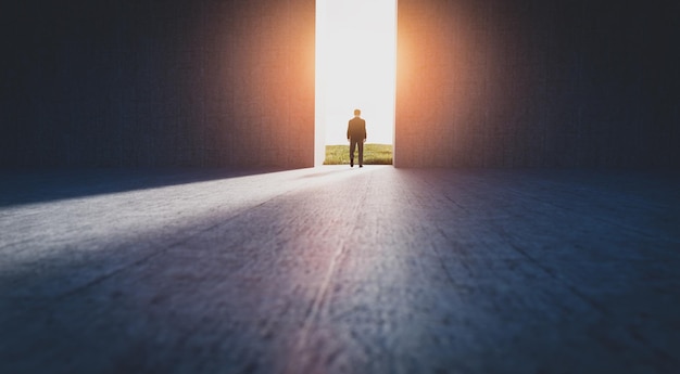 Businessman walking to open gate to a new better green
world