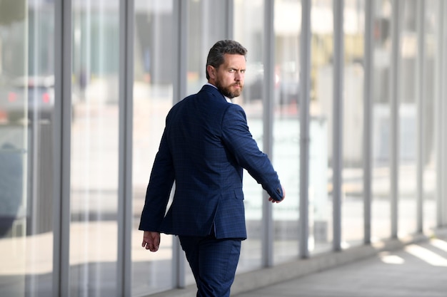 Businessman walking outside business centre portrait of a confident young business man walking in th