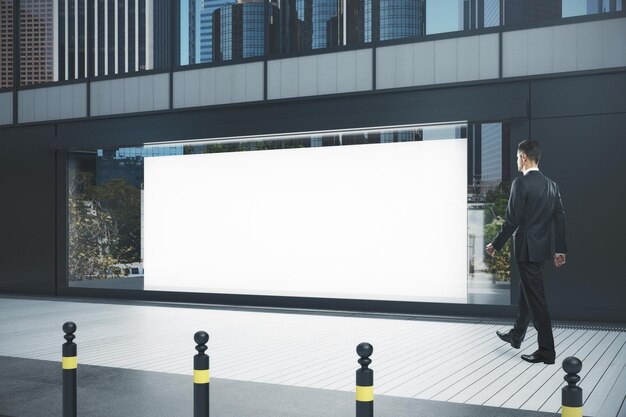 Businessman walking past outdoor showcase with empty poster advertising concept side view mock up 3d rendering