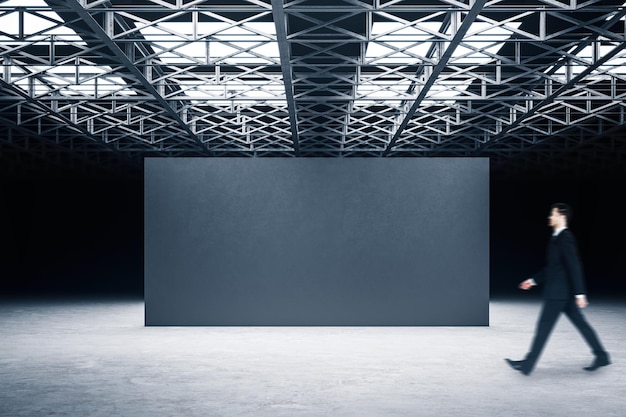 Businessman walking in showroom with exhibition stand