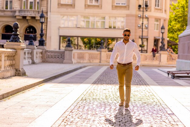A businessman walking on the streets on a sunny day