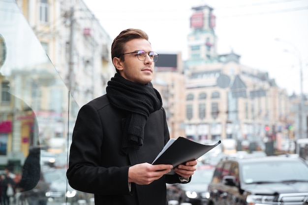 Businessman in warm clothes with folder.