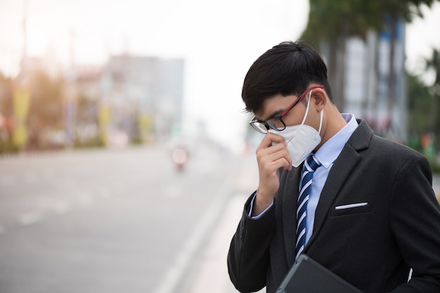 Businessman wearing Protective face mask and cough, Coronavirus and pm 2.5 fighting