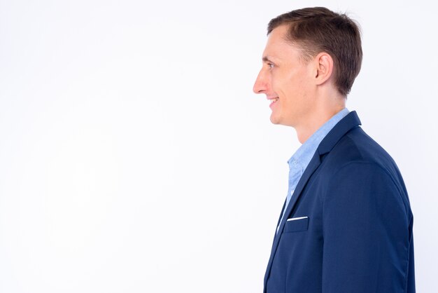 businessman wearing suit isolated against white wall