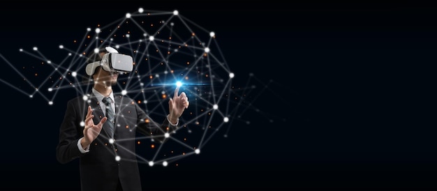 Businessman wearing VR virtual reality headset hand touching virtual screen global link connecting diagram on dark background networking security digital internet communication metaverse concept