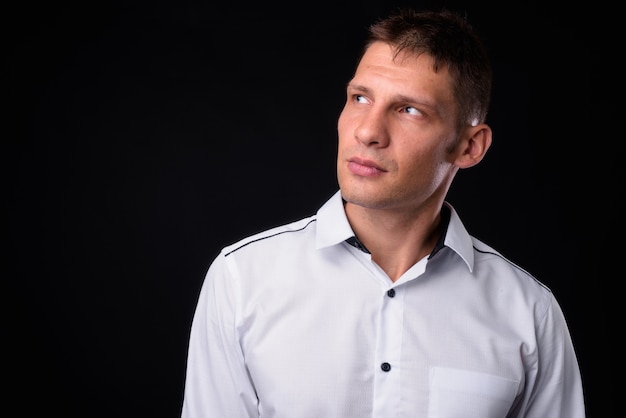 businessman wearing white shirt against black space