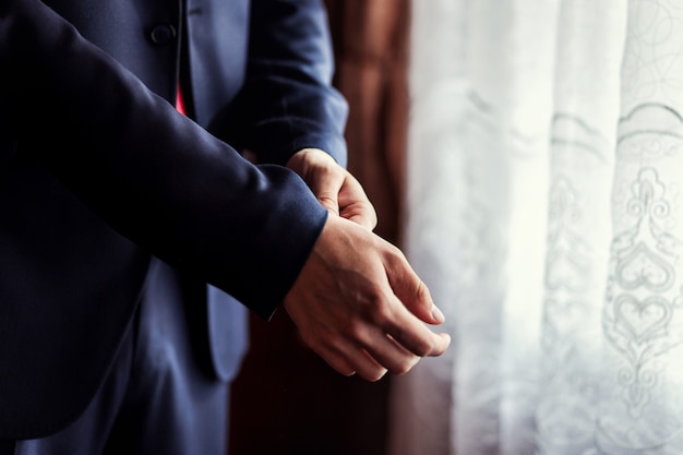 Businessman wears a jacket.Politician, man's style,male hands closeup, American, European businessman, business, fashion and clothing concept