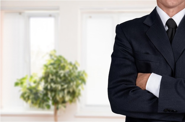 Photo businessman with arms crossed on white