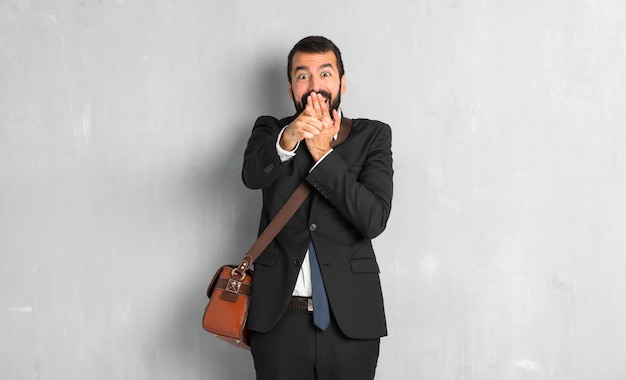 Businessman with beard pointing with finger at someone and laughing