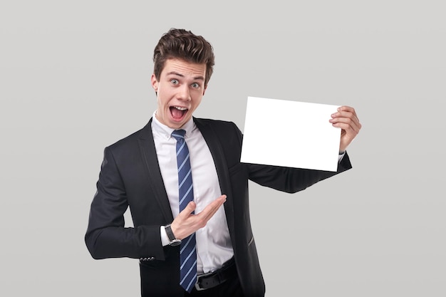 Premium Photo | Businessman with blank paper in studio