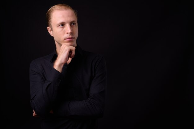 businessman with blond hair on black