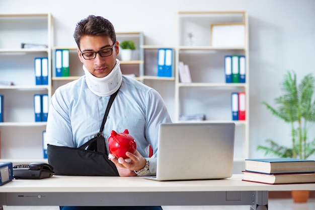 Businessman with broken arm working in office