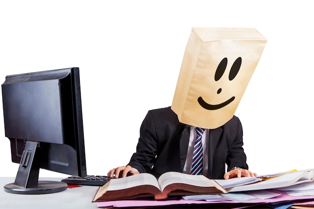 Businessman with cardboard head working on studio