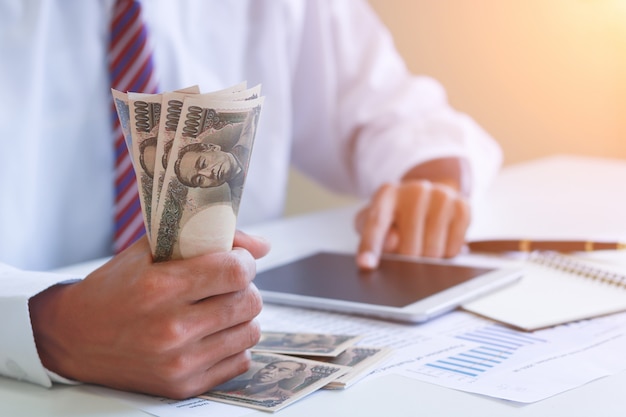 Businessman with cash yen