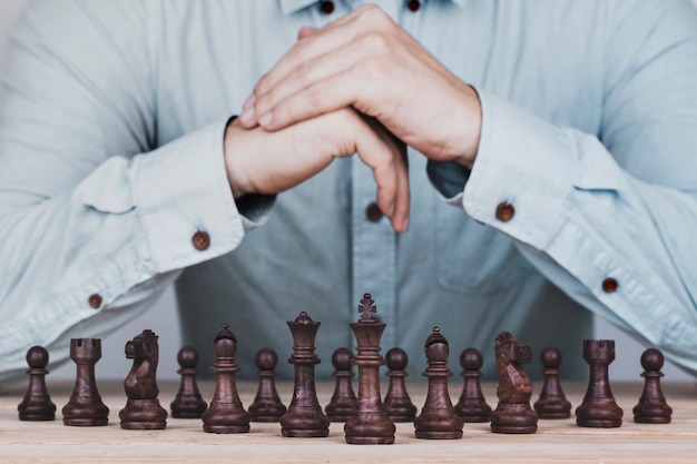 Businessman with clasped hands a brainstorming planning strategy in competition success play , concept strategy and successful management or leadership