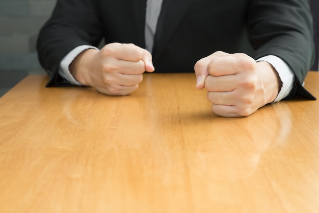 Businessman with clenched fist on the desk at office, Angry concept