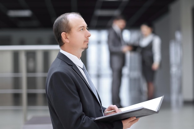 Businessman with clipboard reading a working document.