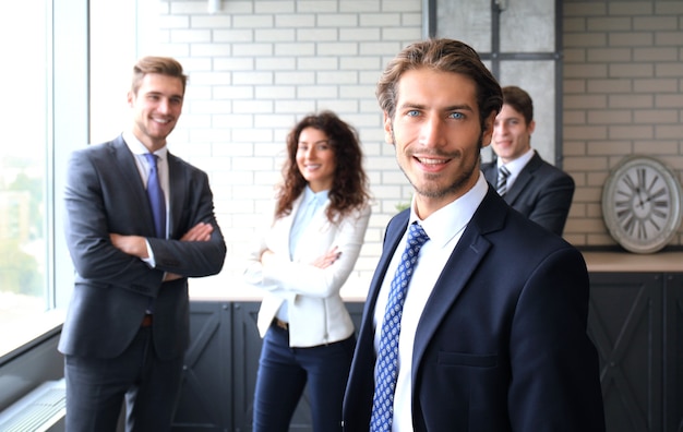 Businessman with colleagues in the background in office