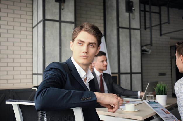 Businessman with colleagues in the background in office