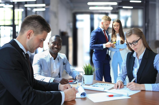 Businessman with colleagues in the background in office