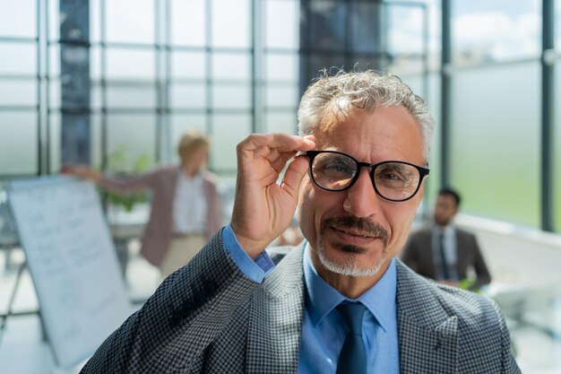 Businessman with colleagues in the background in office