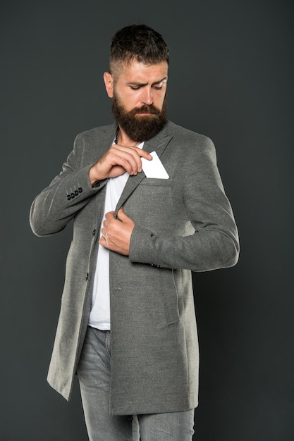 Businessman with credit card. Brutal man with hipster beard. confident businessman in suit. Business fashion and dress code. Bearded man. Male formal fashion. Mature. Earn money easy business tips.