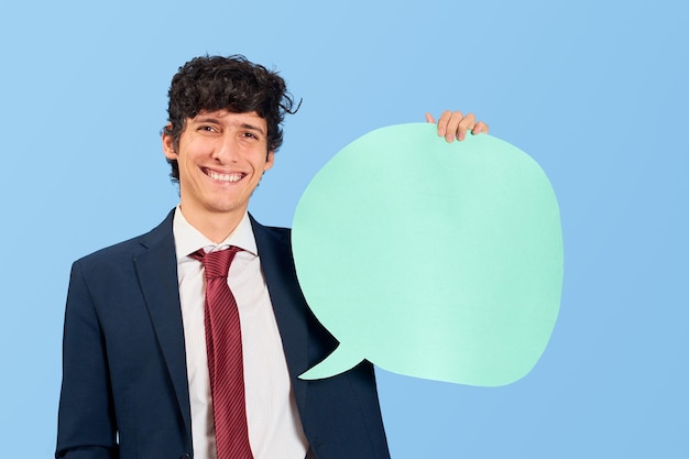 Businessman with dialogue bubble in blank on blue flat lay