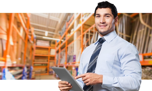 Businessman With Digital Tablet In Warehouse